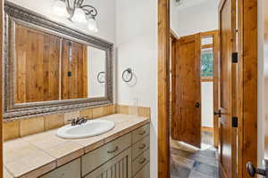 Bathroom with vanity and stone finish flooring
