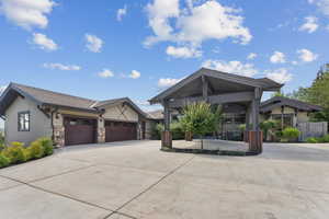 Craftsman house featuring concrete driveway, stucco siding, and a garage