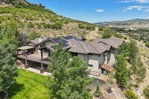 Aerial view of property and surrounding area featuring a mountain backdrop
