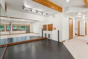 Miscellaneous room with recessed lighting, beam ceiling, and finished concrete floors