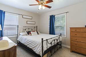 Bedroom with light carpet and ceiling fan