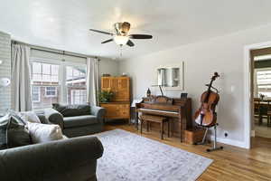 Living area featuring light wood-style floors and a ceiling fan