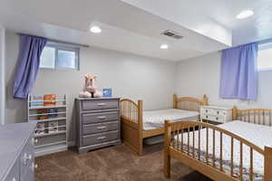 Carpeted bedroom with recessed lighting and a textured ceiling