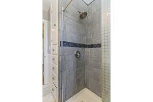 Full bath featuring a tile shower