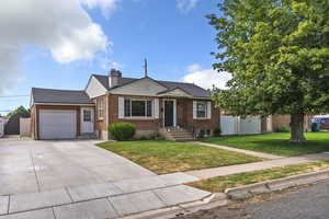 View of front of property with an attached garage, brick siding, concrete driveway, and a shingled roof