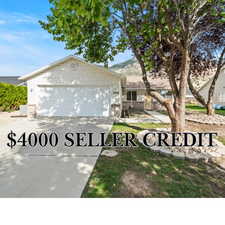 View of front of property featuring brick siding, concrete driveway, and a garage