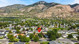 View of property location with mountains and nearby suburban area