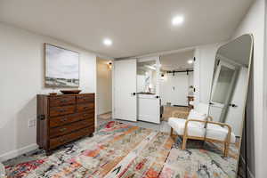 Sitting room with a barn door and recessed lighting