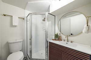 Full bathroom featuring a shower stall and vanity