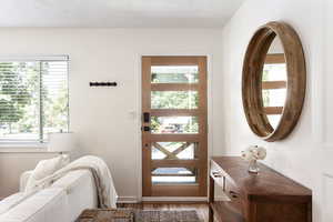 Doorway featuring wood finished floors and plenty of natural light