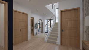 Foyer featuring stairway, light wood-type flooring, and recessed lighting
