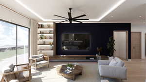 Living area featuring wood finished floors, a ceiling fan, a raised ceiling, and a mountain view