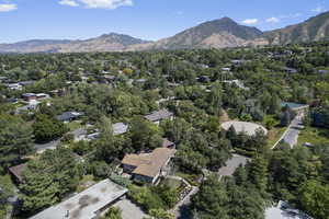 Aerial overview of property's location featuring mountains and nearby suburban area
