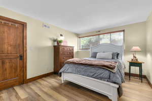 Bedroom featuring light wood-style flooring and baseboards