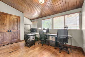 Office area with light wood finished floors, wood ceiling, and vaulted ceiling