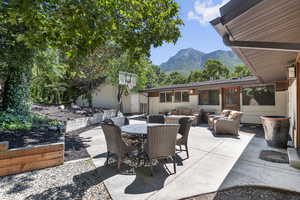 View of patio with an outdoor hangout area, outdoor dining space, and a mountain view