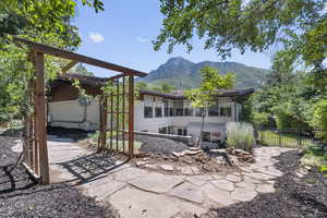 View of patio / terrace with a sunroom and a mountain view