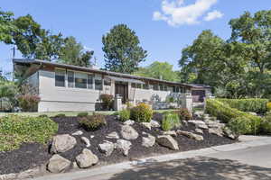 Single story home featuring a chimney