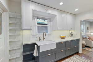 Kitchen featuring gray cabinets, dark wood-style floors, decorative backsplash, white cabinetry, and recessed lighting