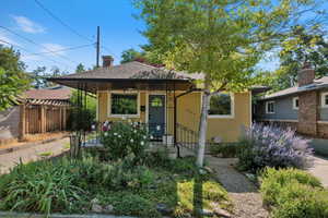 Bungalow with a porch and a chimney