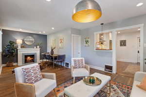 Living area featuring recessed lighting, a fireplace, and wood finished floors
