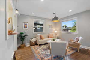 Living area with wood finished floors, recessed lighting, and a baseboard radiator