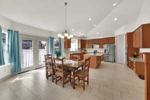 Dining area featuring a chandelier, recessed lighting, and high vaulted ceiling