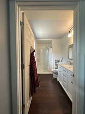 Bathroom featuring wood finished floors, vanity, and a shower with curtain