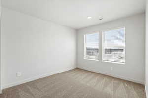 Unfurnished room with light carpet and baseboards