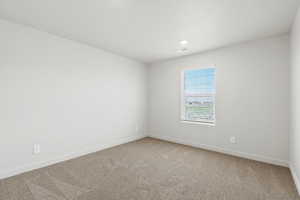 Spare room with light colored carpet and recessed lighting
