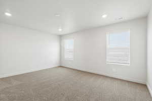 Unfurnished room featuring light carpet and recessed lighting