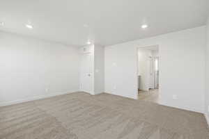 Spare room featuring light colored carpet and recessed lighting