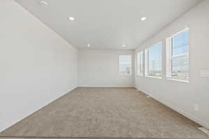 Spare room with light colored carpet and recessed lighting