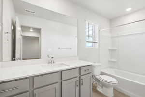 Full bath featuring vanity, bathing tub / shower combination, light wood-style flooring, and recessed lighting