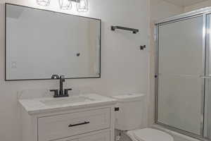 Bathroom with vanity and combined bath / shower with glass door