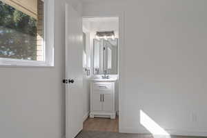 Bathroom featuring vanity and wood finished floors