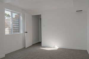 Unfurnished room featuring carpet flooring and baseboards
