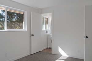 Unfurnished bedroom with carpet floors and baseboards