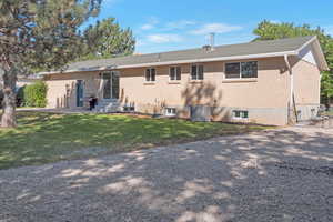 Back of property with a yard