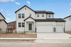 Modern farmhouse style home featuring board and batten siding, driveway, roof with shingles, and an attached garage