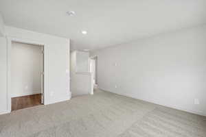 Unfurnished bedroom featuring light colored carpet and recessed lighting
