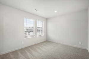 Carpeted empty room with baseboards and recessed lighting
