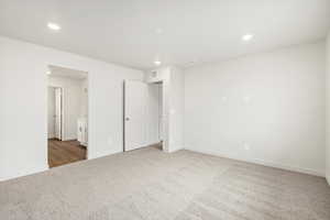 Unfurnished bedroom featuring light colored carpet and recessed lighting