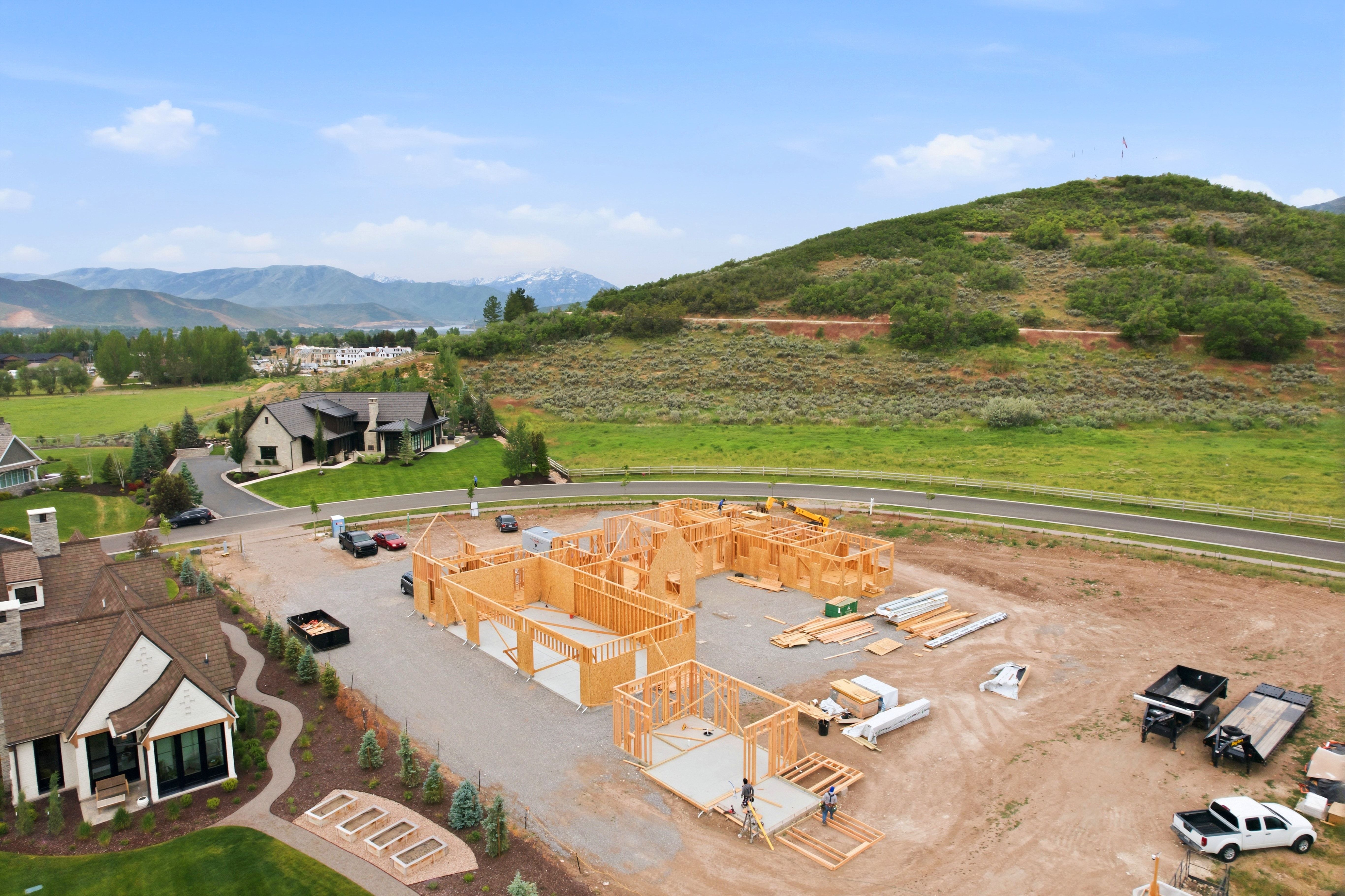 New construction framing underway on a spacious lot