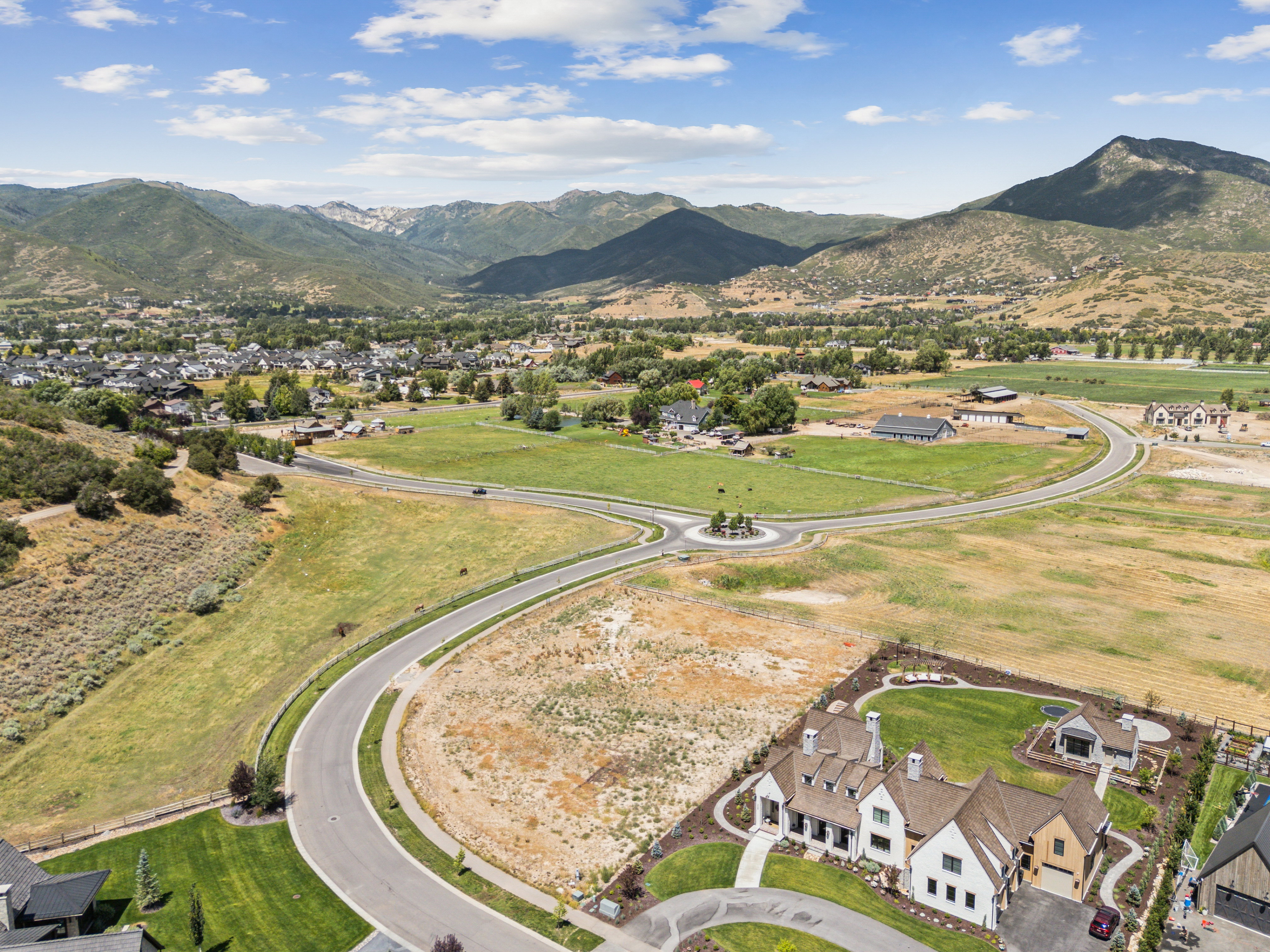 Aerial perspective showcasing a developing residential area with mountainous terrain