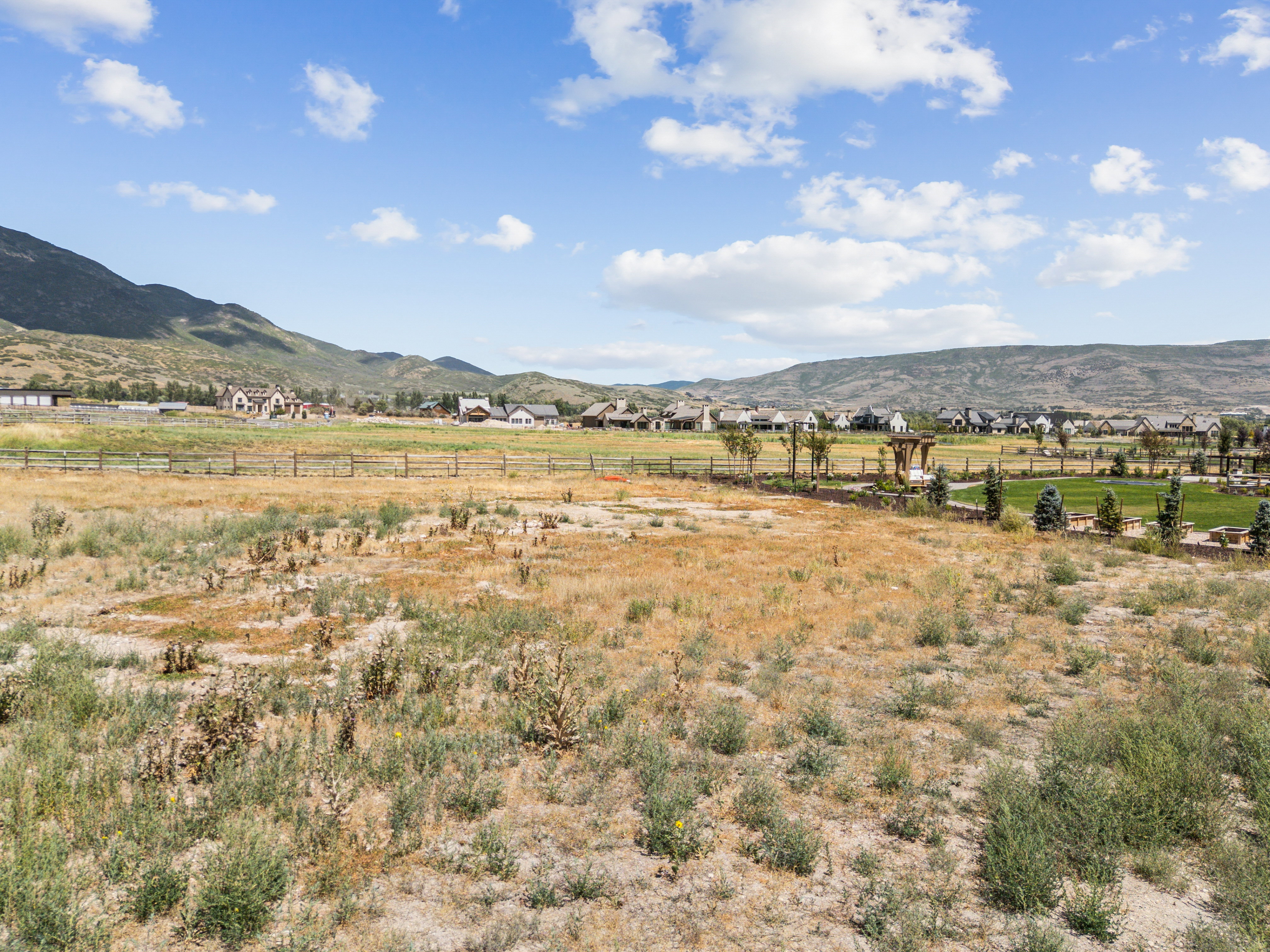 Expansive open field with distant mountain ranges