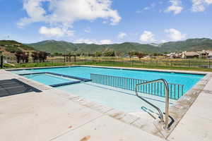 Community pool featuring a patio and a mountain view