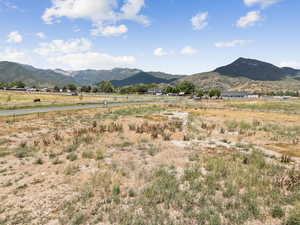 View of mountain backdrop with rural landscape