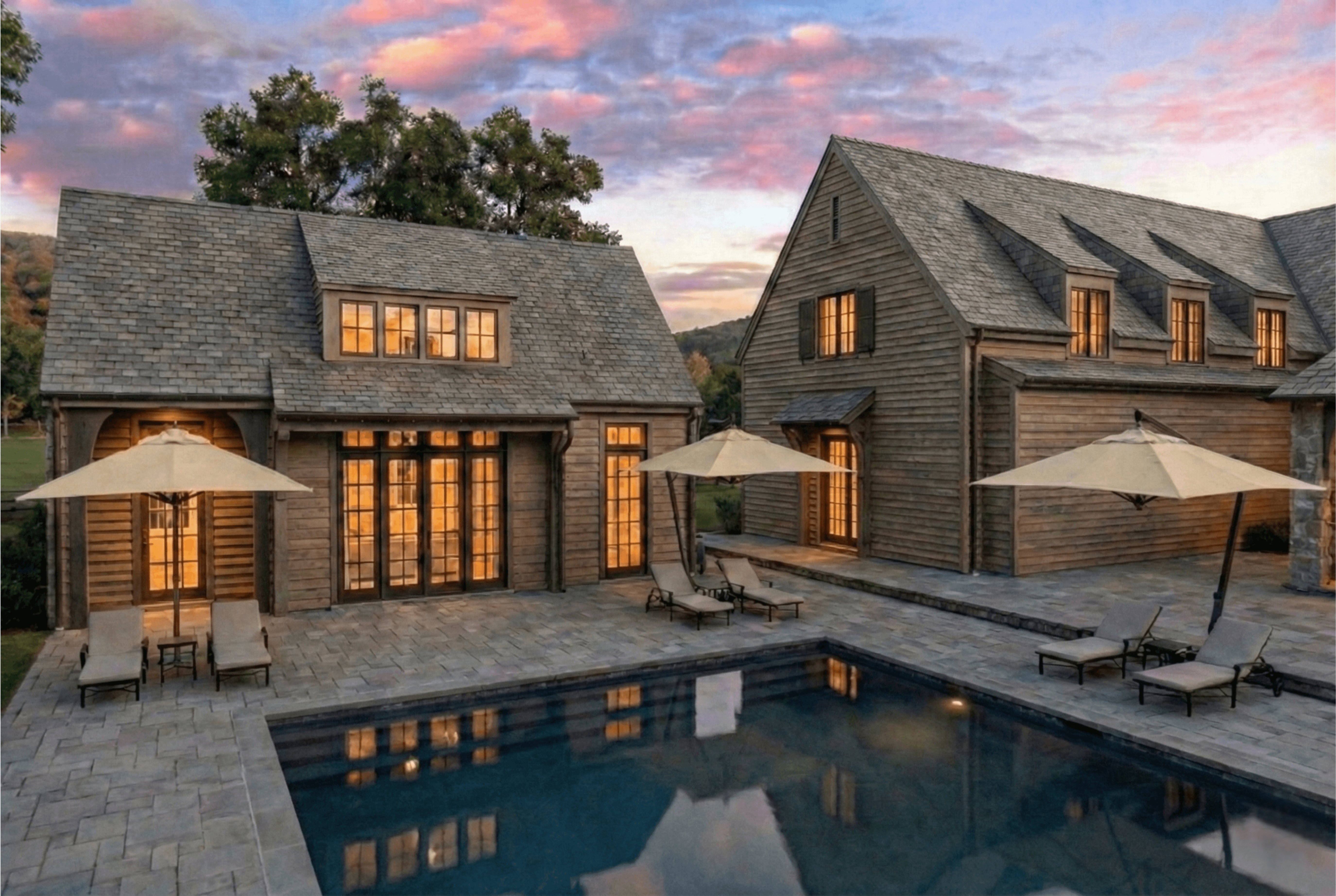 A rectangular swimming pool is bordered by a stone paver patio - Rendering