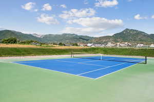 View of tennis court with a mountain view